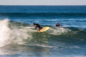 riding an Appletree Jonagold surfboard with cork pad