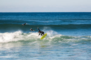 Doing air on Appletree Jonagold yellow surfboard