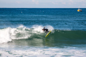 Surfing trick cutback on Appletree Jonagold yellow surfboard